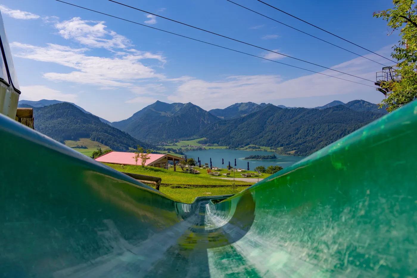The run heads down the slope next to the cable car